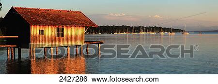 A building and boats moored in the harbour of Ammersee at sunset; Stegen, Bayern, Germany View Large Photo Image Stock Photograph - A building and boats moored in the harbour of Ammersee at sunset; Stegen, Bayern, Germany. Fotosearch