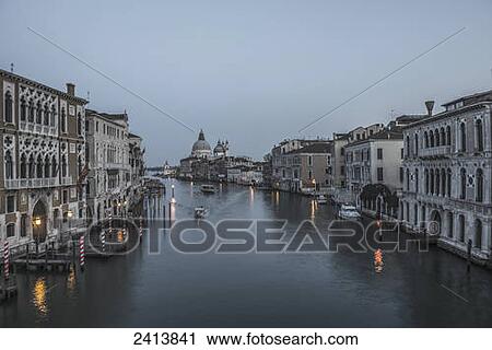 A canal at dusk with the Salute church in the distance; Venice, Veneto, Italy View Large Photo Image Stock Image - A canal at dusk with the Salute church in the distance; Venice, Veneto, Italy. Fotosearch