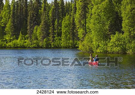 A couple and young girl in a red canoe on Byers lake with green forested shoreline in Byers Lake Campground, Denali State Park; Alaska, United States of America View Large Photo Image Picture - A couple and young girl in a red canoe on Byers lake with green forested shoreline in Byers Lake Campground, Denali State Park; Alaska, United States of America. Fotosearch