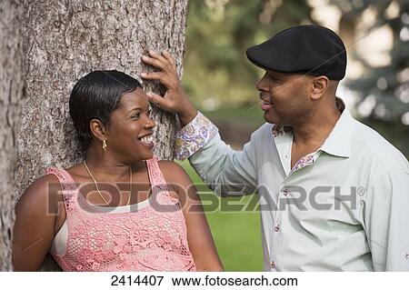 A couple spending quality time together in a park; Edmonton, Alberta, Canada View Large Photo Image Stock Photo - A couple spending quality time together in a park; Edmonton, Alberta, Canada. Fotosearch