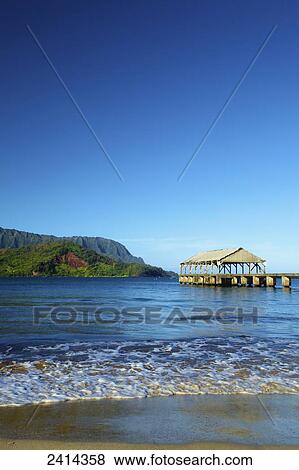 Stock Photo - A covered shelter the end of a pier off Hanalei beach; Kauai, Hawaii, United States of America. Fotosearch