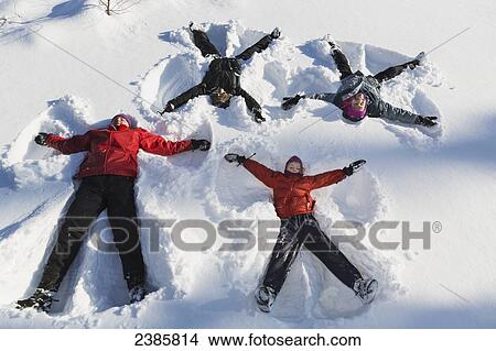 A family making snow angels in wintertime; Talkeetna, Alaska, United States of America View Large Photo Image Picture - A family making snow angels in wintertime; Talkeetna, Alaska, United States of America. Fotosearch