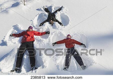 A family making snow angels in wintertime; Talkeetna, Alaska, United States of America View Large Photo Image Stock Image - A family making snow angels in wintertime; Talkeetna, Alaska, United States of America. Fotosearch