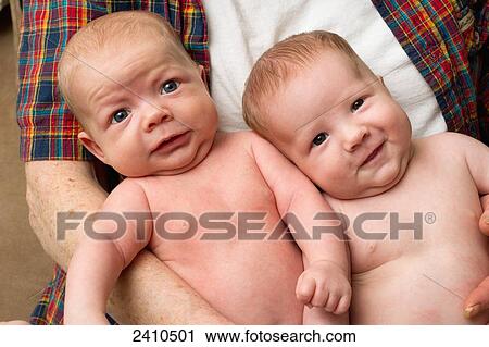 A father holds infant twin brothers; Millet, Alberta, Canada View Large Photo Image Stock Image - A father holds infant twin brothers; Millet, Alberta, Canada. Fotosearch