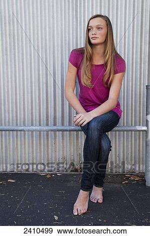 A girl sitting on a metal rail in bare feet; San Francisco, California, United States of America View Large Photo Image Stock Photo - A girl sitting on a metal rail in bare feet; San Francisco, California, United States of America. Fotosearch