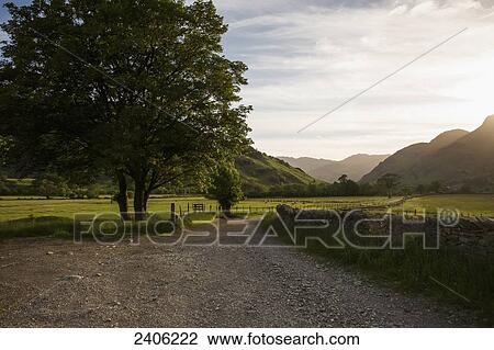 A gravel road in a rural area at sunset; Lake District, Cumbria, England View Large Photo Image Stock Image - A gravel road in a rural area at sunset; Lake District, Cumbria, England. Fotosearch