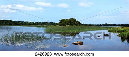 A landscape reflected in tranquil water View Large Photo Image Stock Image - A landscape reflected in tranquil water. Fotosearch