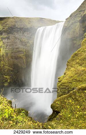 Stock Photo - A majestic waterfall and mist; Iceland. Fotosearch