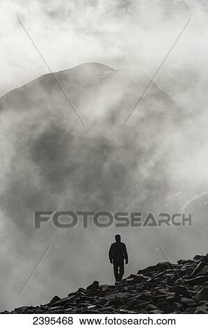 A man walks out of the clouds from the summit of Maol Chean-dearg; Torridon, Scotland View Large Photo Image Stock Photo - A man walks out of the clouds from the summit of Maol Chean-dearg; Torridon, Scotland. Fotosearch