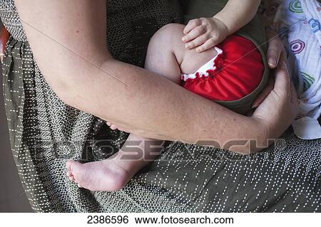 A mother holds her baby; Toronto, Ontario, Canada View Large Photo Image Stock Photograph - A mother holds her baby; Toronto, Ontario, Canada. Fotosearch