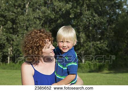 A mother holds her young son; Stony Plain, Alberta, Canada View Large Photo Image Stock Image - A mother holds her young son; Stony Plain, Alberta, Canada. Fotosearch