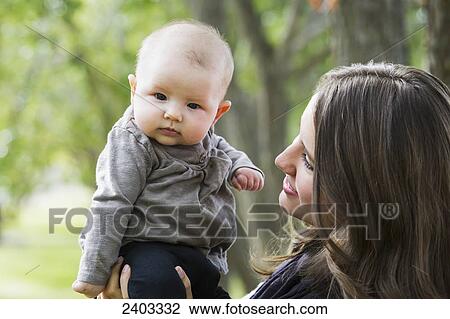 A mother spending quality time with her infant daughter in a park; Edmonton, Alberta, Canada View Large Photo Image Stock Image - A mother spending quality time with her infant daughter in a park; Edmonton, Alberta, Canada. Fotosearch