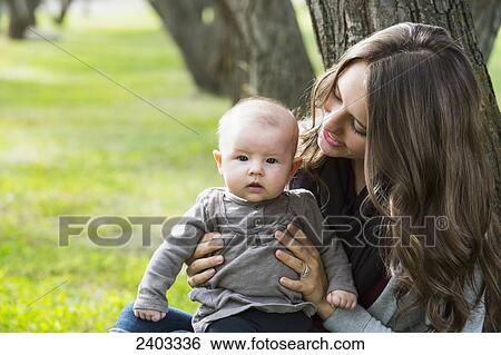 Stock Photograph - A mother spending quality time with her infant daughter in a park; Edmonton, Alberta, Canada. Fotosearch