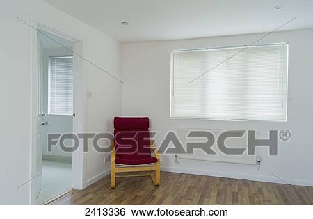 A red chair sits in the corner of a white room; London, England View Large Photo Image Stock Photograph - A red chair sits in the corner of a white room; London, England. Fotosearch