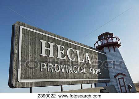 Stock Image - A sign and lighthouse for Hecla Provincial Park; Manitoba, Canada. Fotosearch