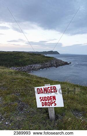 A sign warning a danger and sudden drops along the atlantic coastline; Calvert, Newfoundland and Labrador, Canada View Large Photo Image Stock Image - A sign warning a danger and sudden drops along the atlantic coastline; Calvert, Newfoundland and Labrador, Canada. Fotosearch