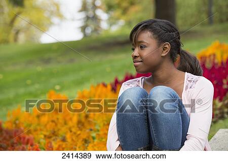 A teenage girl enjoying time outdoors in a park; Edmonton, Alberta, Canada View Large Photo Image Stock Photo - A teenage girl enjoying time outdoors in a park; Edmonton, Alberta, Canada. Fotosearch