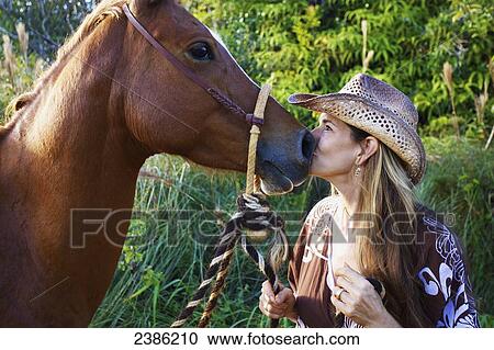 A woman kiss the nose of a horse; Hawaii, United States of America View Large Photo Image Stock Image - A woman kiss the nose of a horse; Hawaii, United States of America. Fotosearch