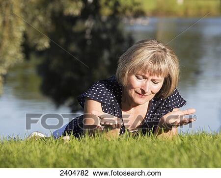 A woman on the grass in a park in prayer; Edmonton, Alberta, Canada View Large Photo Image Stock Image - A woman on the grass in a park in prayer; Edmonton, Alberta, Canada. Fotosearch
