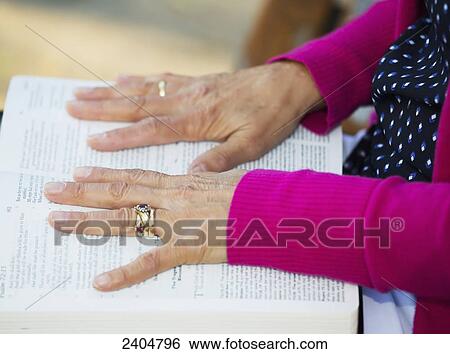 A woman's hands spread open on her Bible; Edmonton, Alberta, Canada View Large Photo Image Stock Photograph - A woman's hands spread open on her Bible; Edmonton, Alberta, Canada. Fotosearch