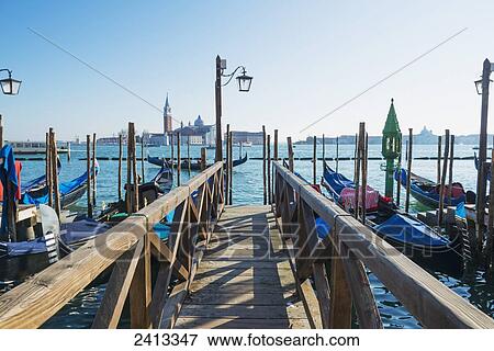 Stock Photo - A wooden dock leading out to the Grand Canal; Venice, Italy. Fotosearch