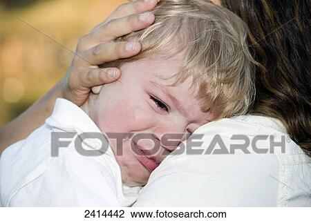 A young boy crying on his mother's shoulder; Edmonton, Alberta, Canada View Large Photo Image Stock Image - A young boy crying on his mother's shoulder; Edmonton, Alberta, Canada. Fotosearch