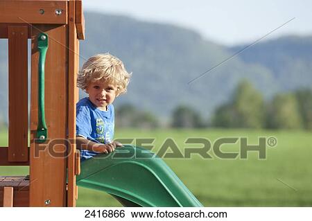 A young boy playing on playground equipment; Thunder Bay, Ontario, Canada View Large Photo Image Stock Photograph - A young boy playing on playground equipment; Thunder Bay, Ontario, Canada. Fotosearch