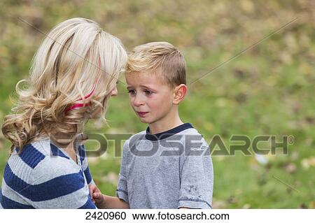 A young boy who is hurt and seeks comfort from his mother; Edmonton, Alberta, Canada View Large Photo Image Stock Image - A young boy who is hurt and seeks comfort from his mother; Edmonton, Alberta, Canada. Fotosearch