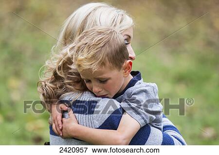 A young boy who is hurt and seeks comfort from his mother; Edmonton, Alberta, Canada View Large Photo Image Stock Photo - A young boy who is hurt and seeks comfort from his mother; Edmonton, Alberta, Canada. Fotosearch