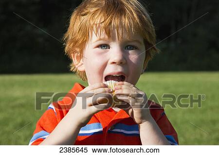 A young boy with red hair eating; Stony Plain, Alberta, Canada View Large Photo Image Stock Photography - A young boy with red hair eating; Stony Plain, Alberta, Canada. Fotosearch
