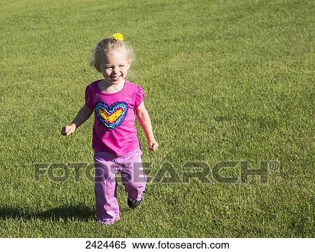 A young girl running on grass in a park; St. Albert, Alberta, Canada View Large Photo Image Stock Photography - A young girl running on grass in a park; St. Albert, Alberta, Canada. Fotosearch