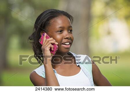 A young girl using a smart phone in a park; Edmonton, Alberta, Canada View Large Photo Image Stock Image - A young girl using a smart phone in a park; Edmonton, Alberta, Canada. Fotosearch