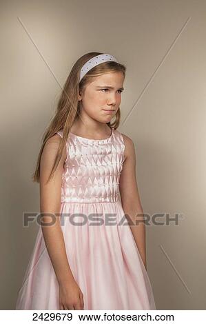 A young girl with an unhappy facial expression; Connecticut, United States of America View Large Photo Image Stock Photo - A young girl with an unhappy facial expression; Connecticut, United States of America. Fotosearch