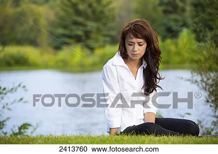 A young woman taking time for herself in a park; Edmonton, Alberta, Canada View Large Photo Image Stock Image - A young woman taking time for herself in a park; Edmonton, Alberta, Canada. Fotosearch