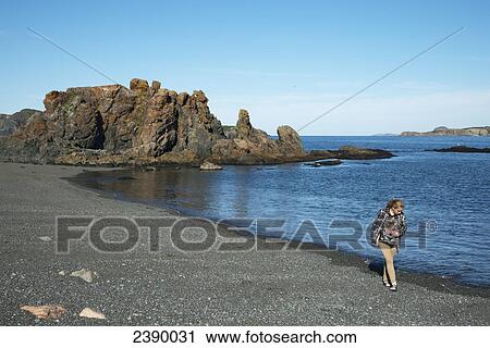 A young woman walks on the rocky beach along the atlantic coast; North Twillingate Island, Newfoundland and Labrador, Canada View Large Photo Image Stock Image - A young woman walks on the rocky beach along the atlantic coast; North Twillingate Island, Newfoundland and Labrador, Canada. Fotosearch
