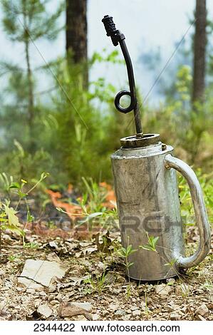 Agriculture - A drip torch sitting on the forest floor. / Ouachita Mountains, Arkansas, USA. View Large Photo Image Stock Image - Agriculture - A drip torch sitting on the forest floor. / Ouachita Mountains, Arkansas, USA.. Fotosearch