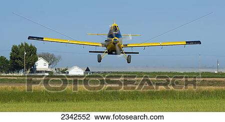 Agriculture - Aerial seeding of a rice field with a dairy farm in the background / near Escalon, San Joaquin County, California, USA. View Large Photo Image Stock Image - Agriculture - Aerial seeding of a rice field with a dairy farm in the background / near Escalon, San Joaquin County, California, USA.. Fotosearch