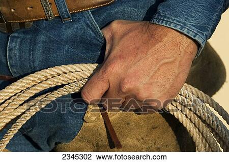 Agriculture - Closeup of a cowboys hand holding a lasso rope / Childress, Texas, USA. View Large Photo Image Stock Image - Agriculture - Closeup of a cowboys hand holding a lasso rope / Childress, Texas, USA.. Fotosearch