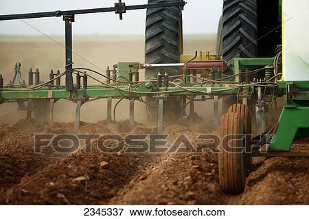 Agriculture - Closeup of a field implement preparing a field for planting cotton and applying liquid fertilizer / Childress, Texas, USA. View Large Photo Image Stock Photo - Agriculture - Closeup of a field implement preparing a field for planting cotton and applying liquid fertilizer / Childress, Texas, USA.. Fotosearch