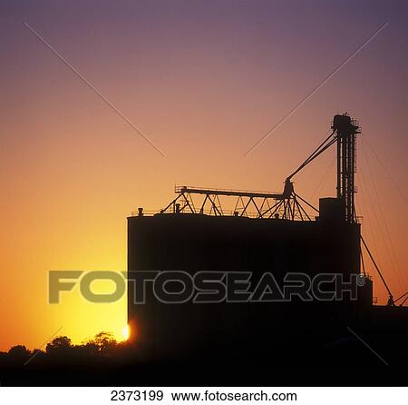 Agriculture - Grain elevators silhouetted by the sunset / Ontario, Canada. View Large Photo Image Stock Photo - Agriculture - Grain elevators silhouetted by the sunset / Ontario, Canada.. Fotosearch