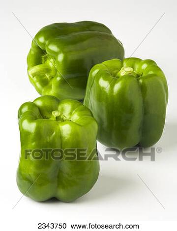 Stock Image - Agriculture - Green Bell peppers on a white surface.. Fotosearch
