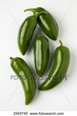 Stock Image - Agriculture - Jalapeno peppers on a white surface.. Fotosearch