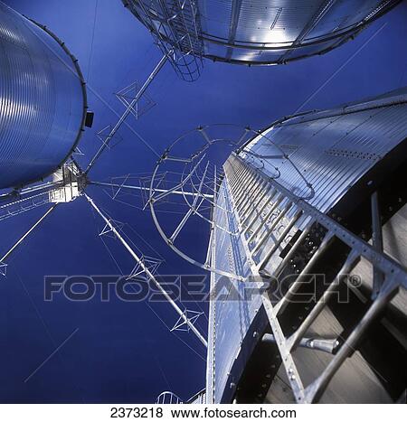 Stock Photo - Agriculture - View looking straight up at grain elevators and grain legs / Ontario, Canada.. Fotosearch