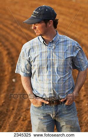 Agriculture - Young farmer inspecting his cultivated field / Childress, Texas, USA. View Large Photo Image Stock Photography - Agriculture - Young farmer inspecting his cultivated field / Childress, Texas, USA.. Fotosearch