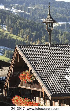 Alpine house top with colourful flower boxes and roof top ornament (small bell tower); Alpbach, Austria View Large Photo Image Stock Photo - Alpine house top with colourful flower boxes and roof top ornament (small bell tower); Alpbach, Austria. Fotosearch