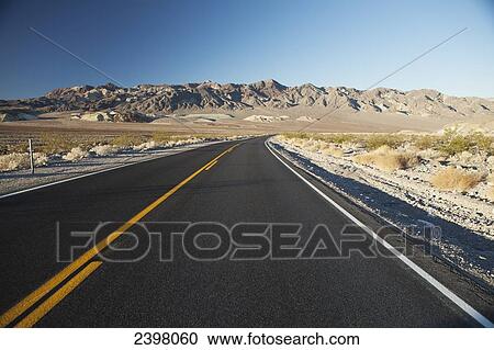 Stock Image - Amargosa Range and Hwy 190, near east entrance to Death Valley near town of Pahrump, Death Valley National Park; California, United States of America. Fotosearch
