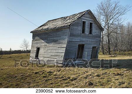 An abandoned wooden house leaning to one side; Manitoba, Canada View Large Photo Image Stock Image - An abandoned wooden house leaning to one side; Manitoba, Canada. Fotosearch