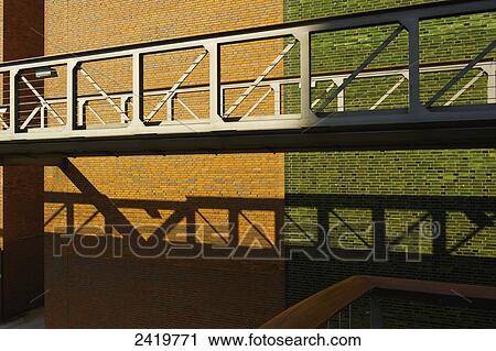 An elevated walkway with a brick wall behind it in two colours, brown and green; Hamburg, Germany View Large Photo Image Stock Image - An elevated walkway with a brick wall behind it in two colours, brown and green; Hamburg, Germany. Fotosearch