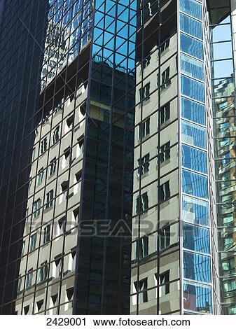 An office tower reflects a residential building in the glass windows; Montreal, Quebec, Canada View Large Photo Image Stock Image - An office tower reflects a residential building in the glass windows; Montreal, Quebec, Canada. Fotosearch