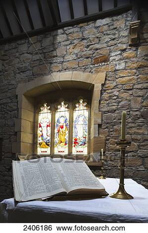 An open Bible on display in a church with colourful stained glass windows; Helmsley, North Yorkshire, England View Large Photo Image Stock Photograph - An open Bible on display in a church with colourful stained glass windows; Helmsley, North Yorkshire, England. Fotosearch